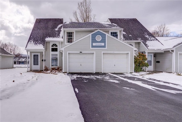 view of front of house featuring a shingled roof and a garage