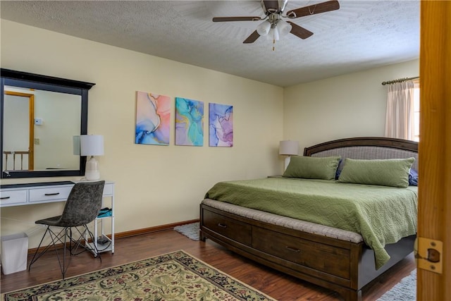 bedroom featuring ceiling fan, wood finished floors, baseboards, and a textured ceiling