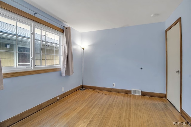 unfurnished room featuring visible vents, baseboards, and light wood finished floors