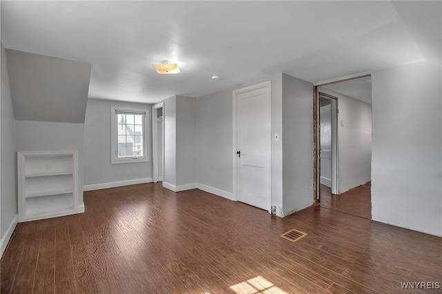 additional living space featuring visible vents, baseboards, and wood finished floors