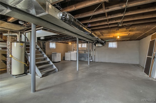 basement with washing machine and dryer, gas water heater, stairs, and a healthy amount of sunlight