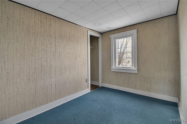 carpeted spare room with baseboards