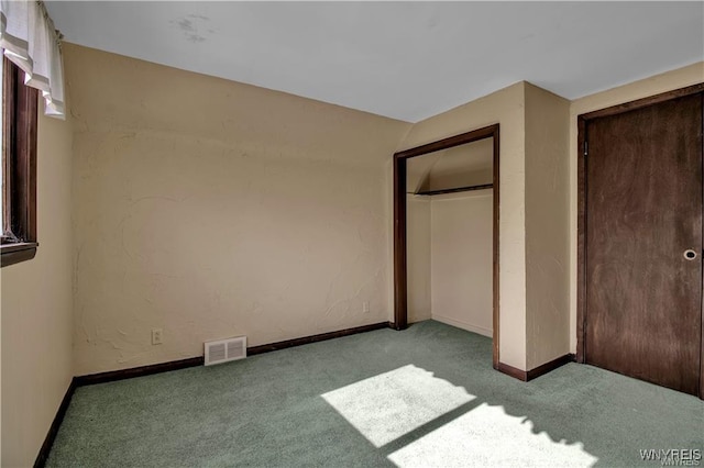 unfurnished bedroom with a closet, baseboards, visible vents, and carpet floors