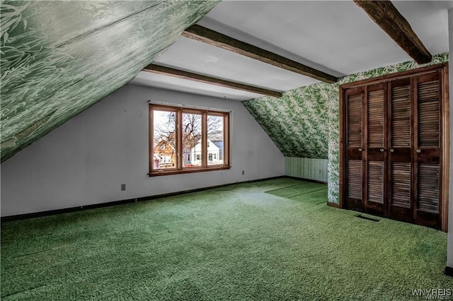 additional living space featuring lofted ceiling with beams, baseboards, carpet floors, and visible vents