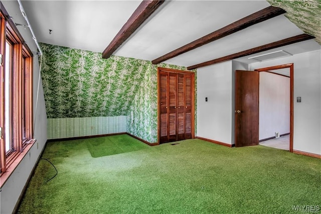 carpeted spare room with beamed ceiling, wallpapered walls, and baseboards