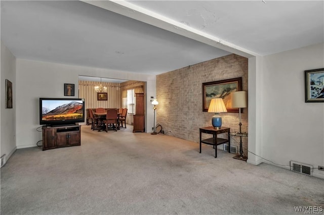 sitting room with visible vents, brick wall, and carpet floors