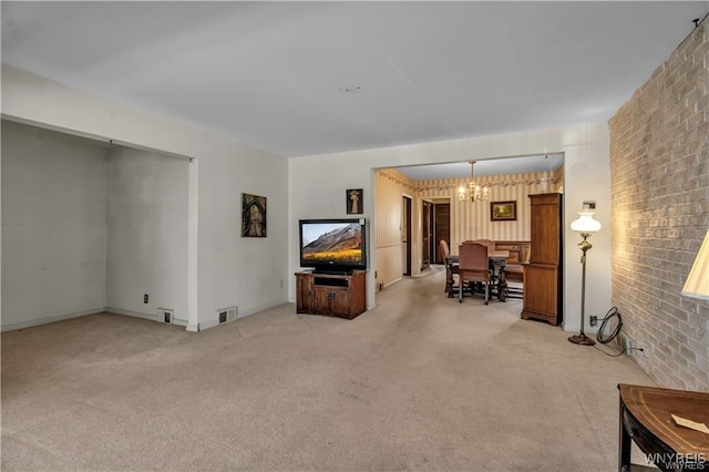 living area featuring visible vents, light carpet, a chandelier, and brick wall