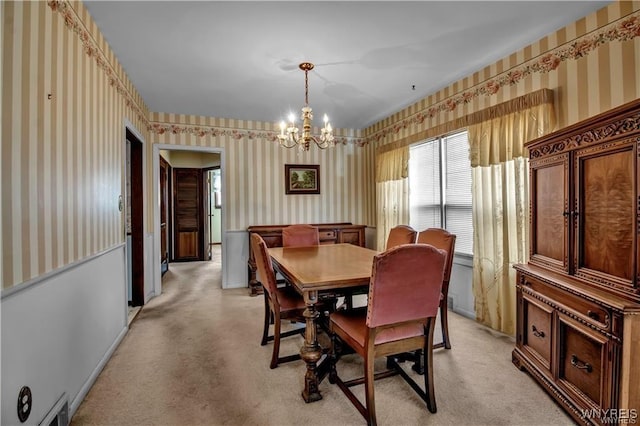 dining room with light colored carpet, wallpapered walls, and an inviting chandelier