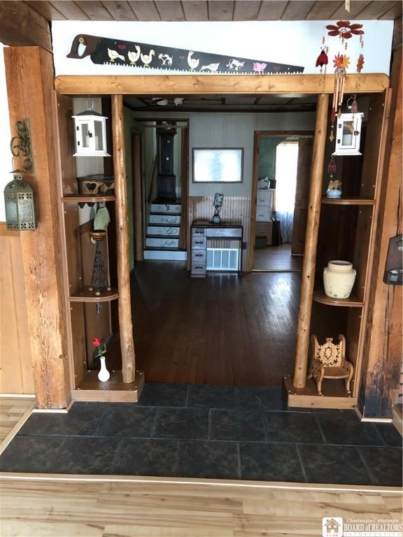 corridor featuring stairway and wood finished floors