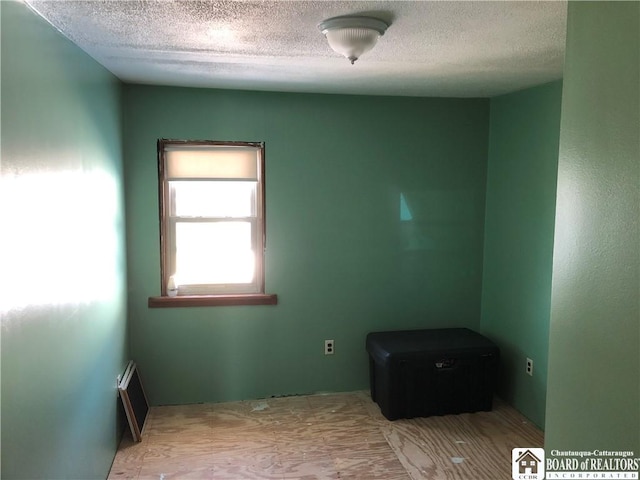 unfurnished room featuring a textured ceiling