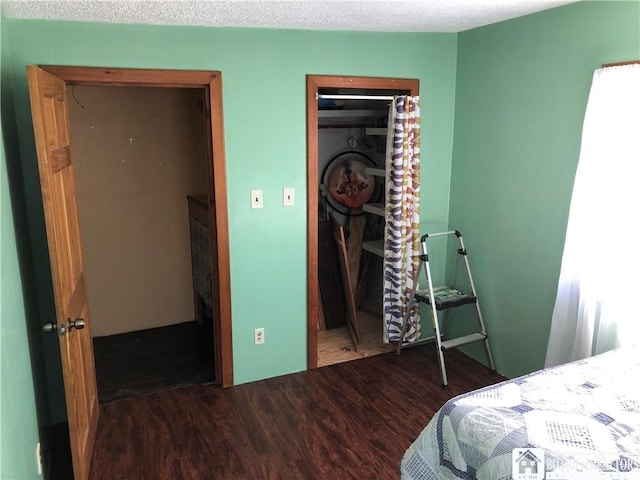 bedroom with wood finished floors, a closet, and a textured ceiling