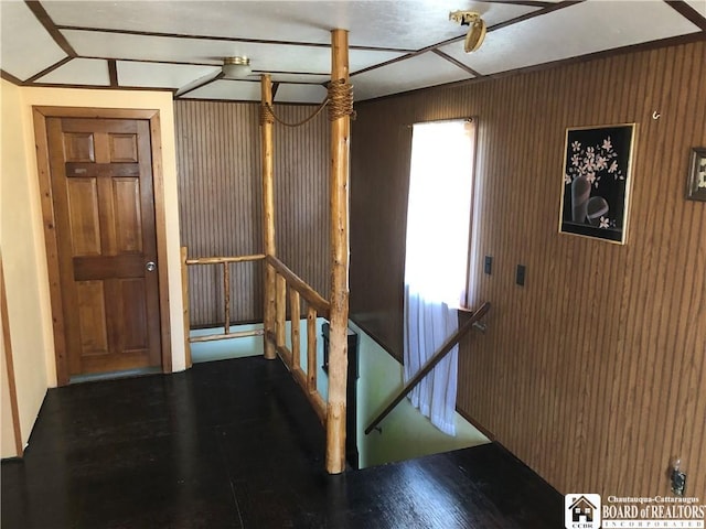 hallway featuring wood finished floors and an upstairs landing