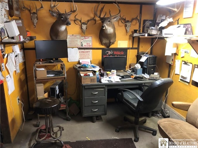 home office featuring concrete flooring