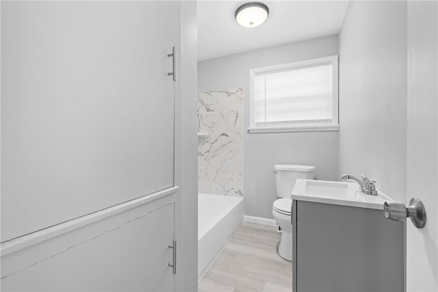 full bath with toilet, vanity, and wood finished floors