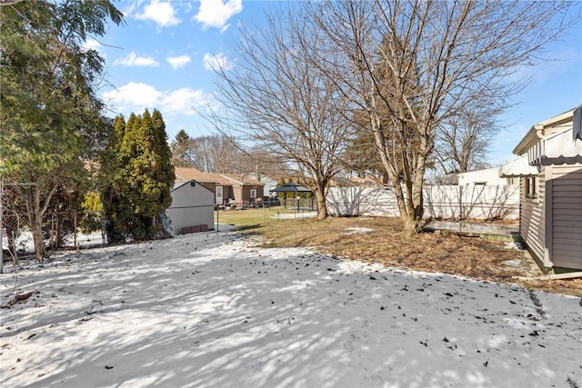 snowy yard with fence and a residential view