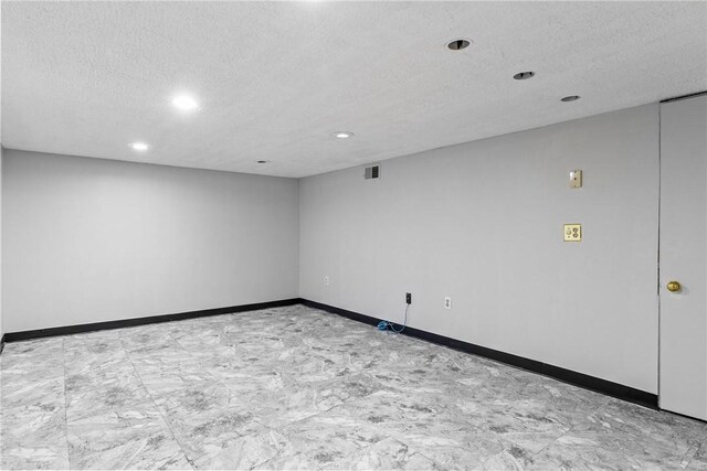 empty room featuring recessed lighting, visible vents, baseboards, and a textured ceiling