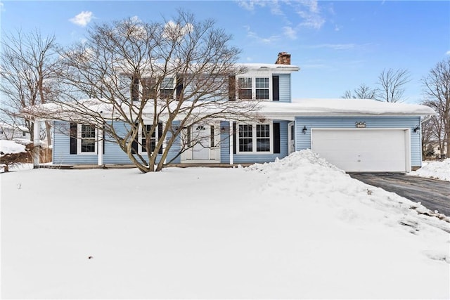 view of front of home featuring a garage, driveway, and a chimney