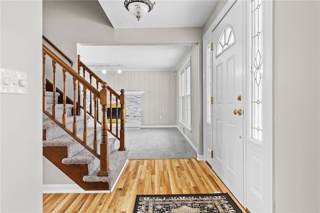 entryway featuring stairs, wood finished floors, and baseboards