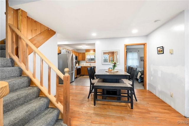 dining area featuring recessed lighting, stairway, and light wood-style flooring