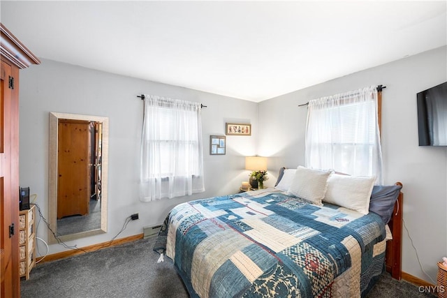 carpeted bedroom featuring multiple windows, a baseboard heating unit, and baseboards