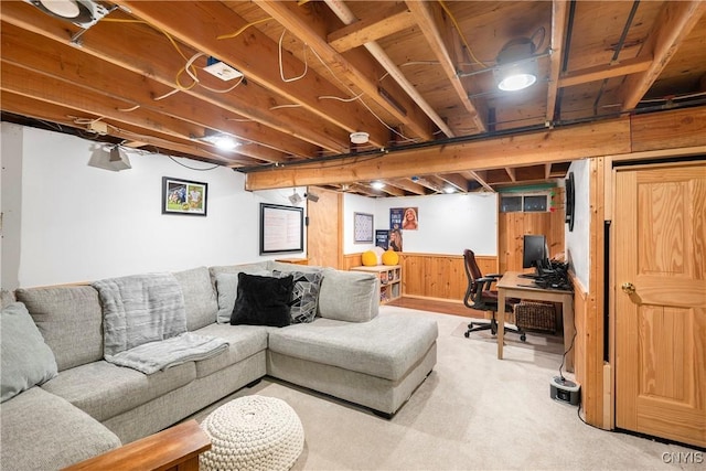 carpeted living room with wainscoting and wood walls