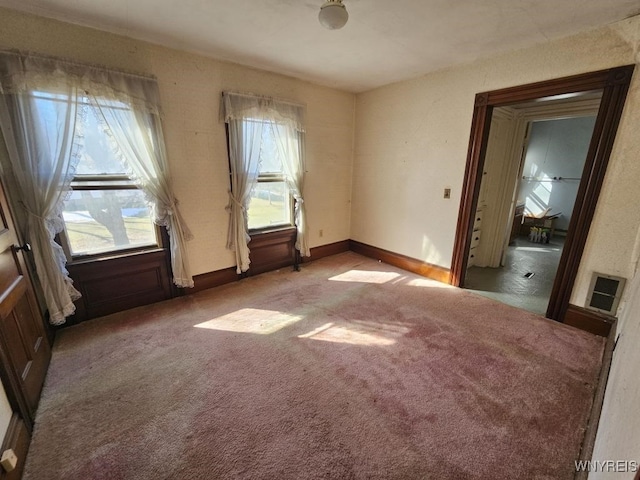 carpeted empty room with baseboards and visible vents