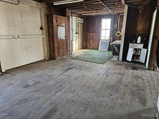 misc room featuring wood walls and hardwood / wood-style flooring