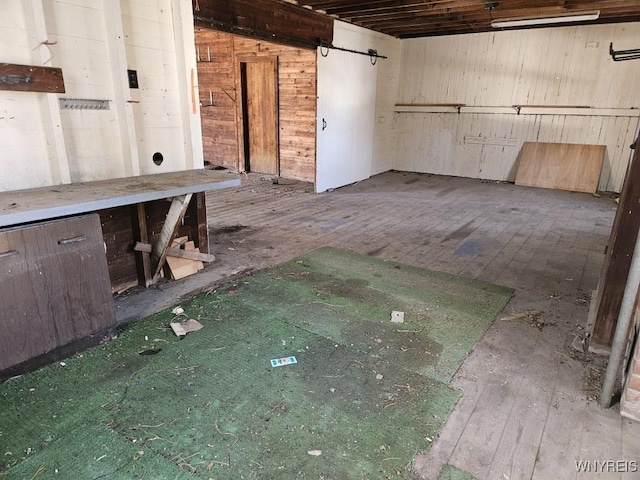 interior space featuring a barn door and wood walls