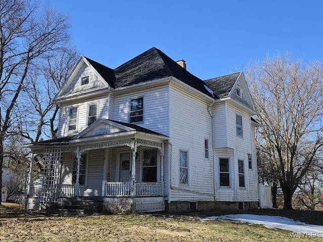 view of front of property featuring covered porch and a chimney