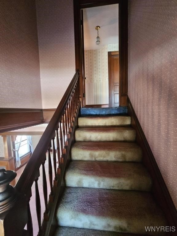 stairway with wallpapered walls