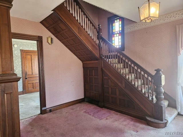 staircase with carpet flooring, wallpapered walls, and baseboards