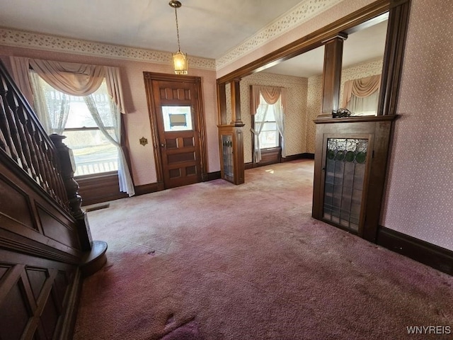 carpeted entrance foyer with wallpapered walls, visible vents, and baseboards