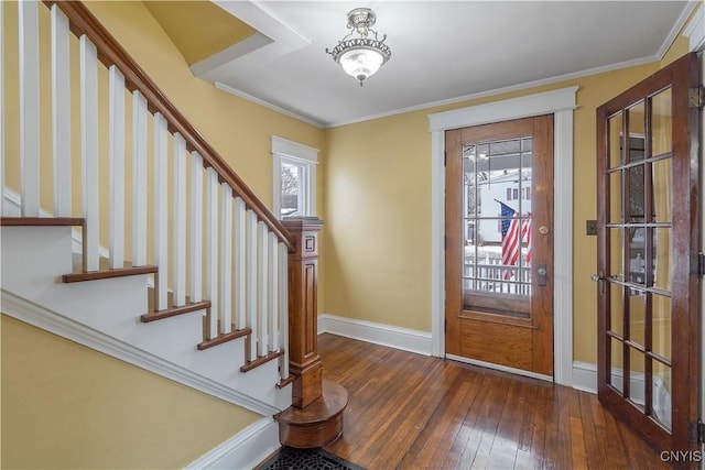 entrance foyer with crown molding, plenty of natural light, baseboards, and wood-type flooring