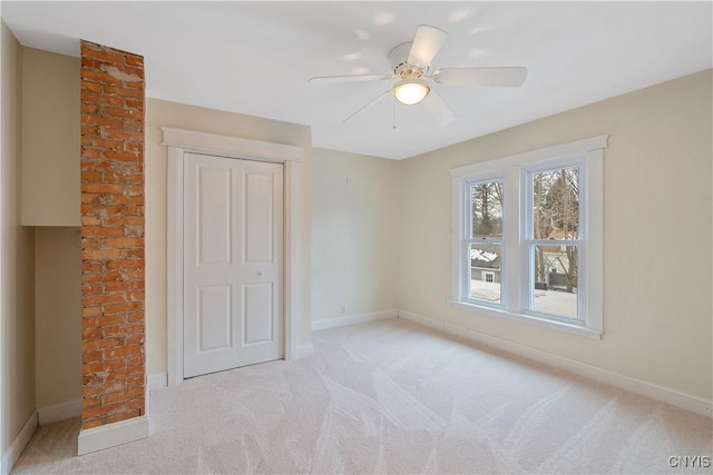 unfurnished bedroom featuring carpet flooring, a ceiling fan, and baseboards