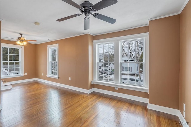 interior space featuring crown molding, baseboards, and wood-type flooring