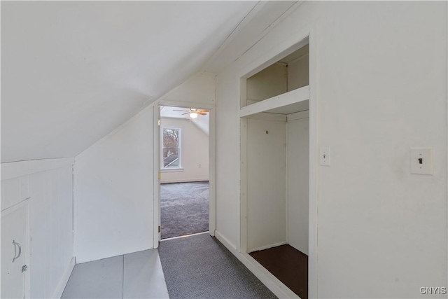 interior space featuring carpet flooring and vaulted ceiling