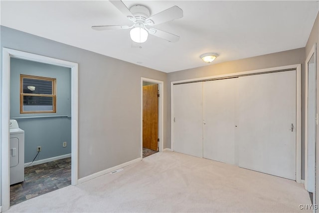 unfurnished bedroom with a ceiling fan, baseboards, carpet floors, washer / clothes dryer, and a closet