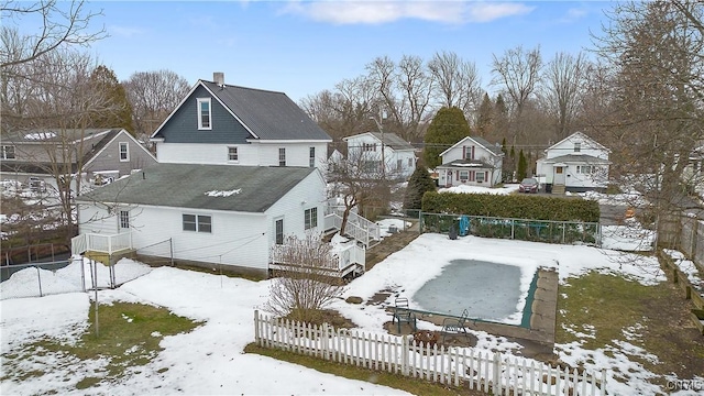 snowy aerial view with a residential view