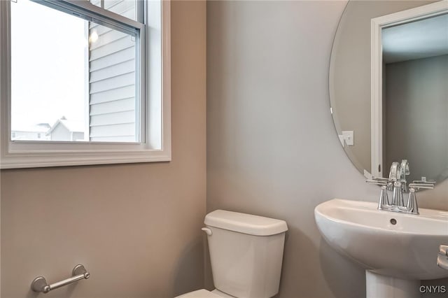 half bath with a sink and toilet