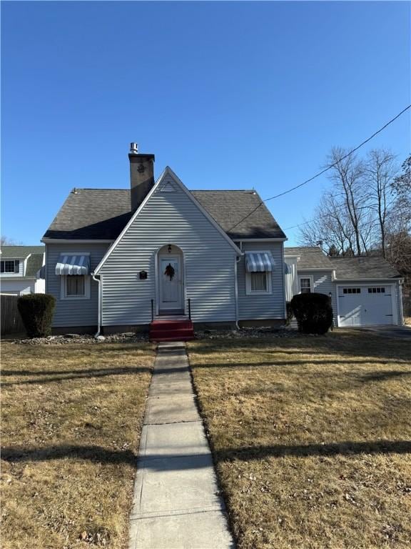 view of front of house with entry steps, a chimney, and a front lawn