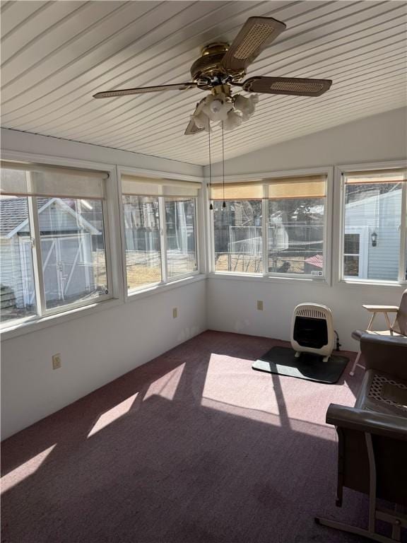 unfurnished sunroom featuring wood ceiling and a ceiling fan