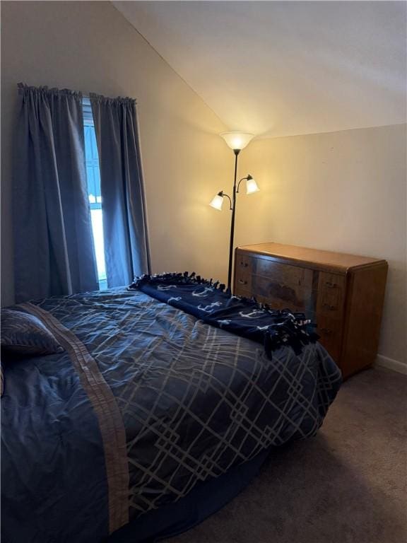 carpeted bedroom with vaulted ceiling