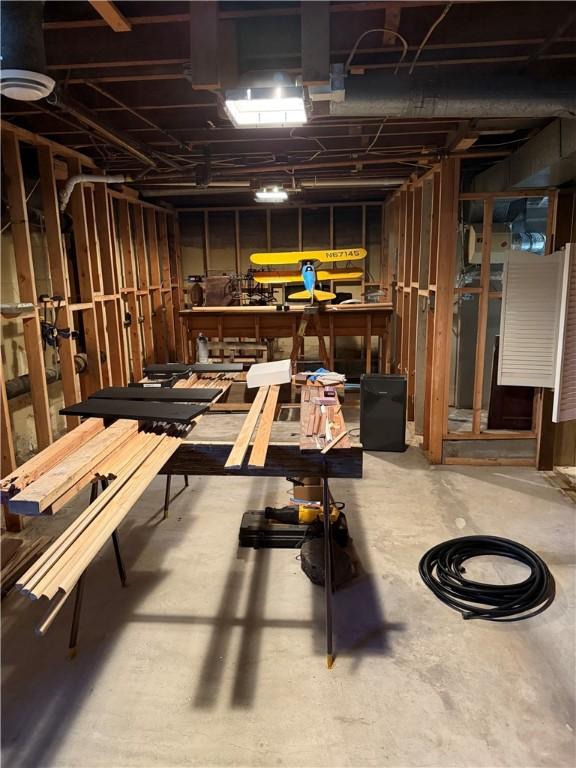 miscellaneous room with a workshop area and concrete flooring