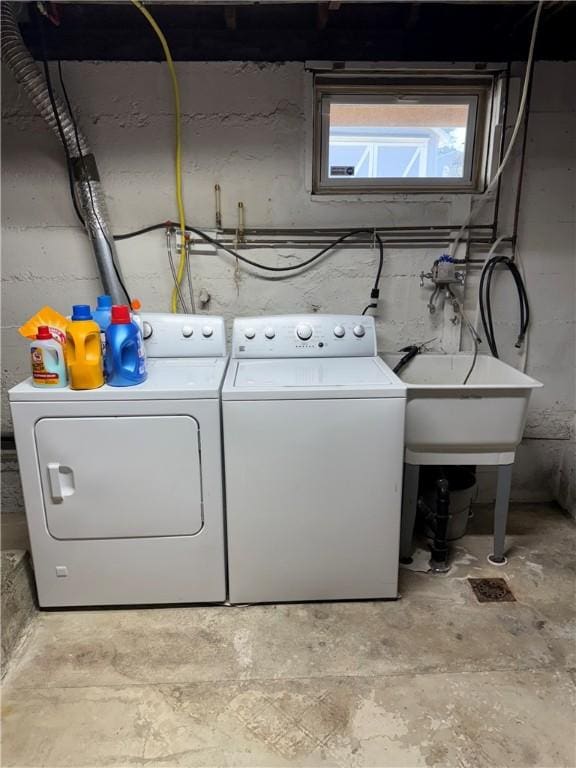 clothes washing area featuring a sink, independent washer and dryer, and laundry area