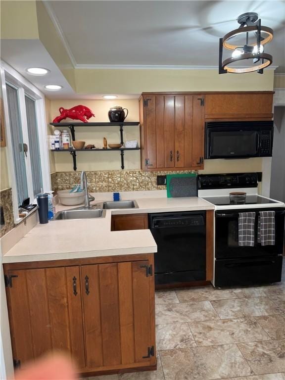 kitchen with brown cabinetry, ornamental molding, a sink, black appliances, and light countertops