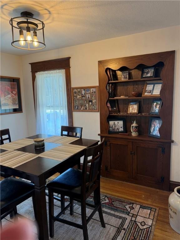 dining area featuring a chandelier and wood finished floors