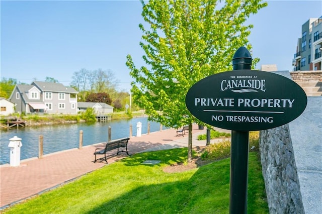 view of community with a water view and a lawn