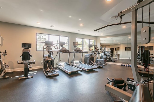 exercise room with recessed lighting, visible vents, and baseboards