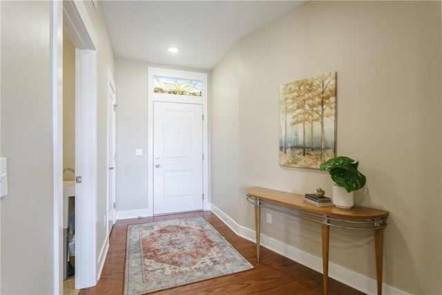 entryway featuring recessed lighting, wood finished floors, and baseboards