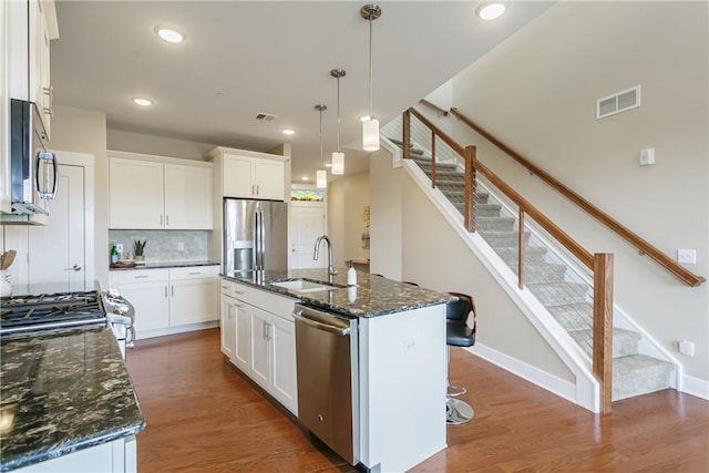 kitchen with dark wood-style floors, visible vents, stainless steel appliances, and a sink